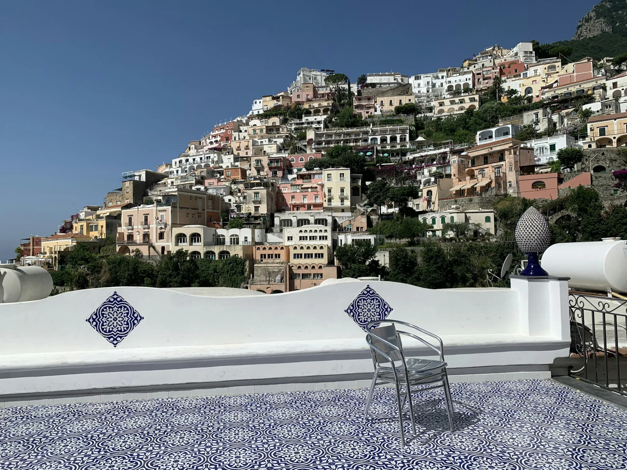 A terrace with a tiled floor, Positano opposite