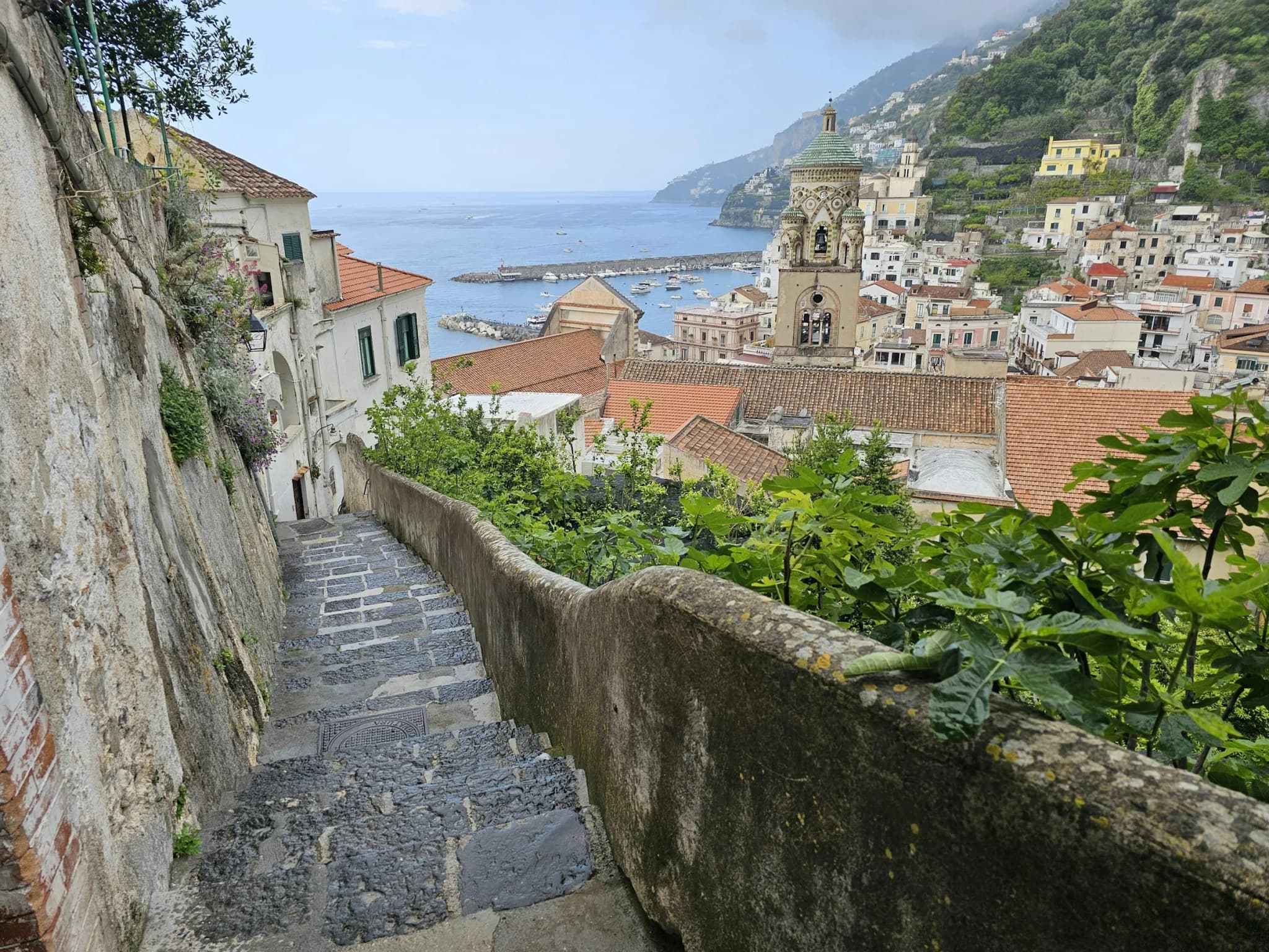 Stone steps leading down to Amalfi, the cathedral bell tower beyond