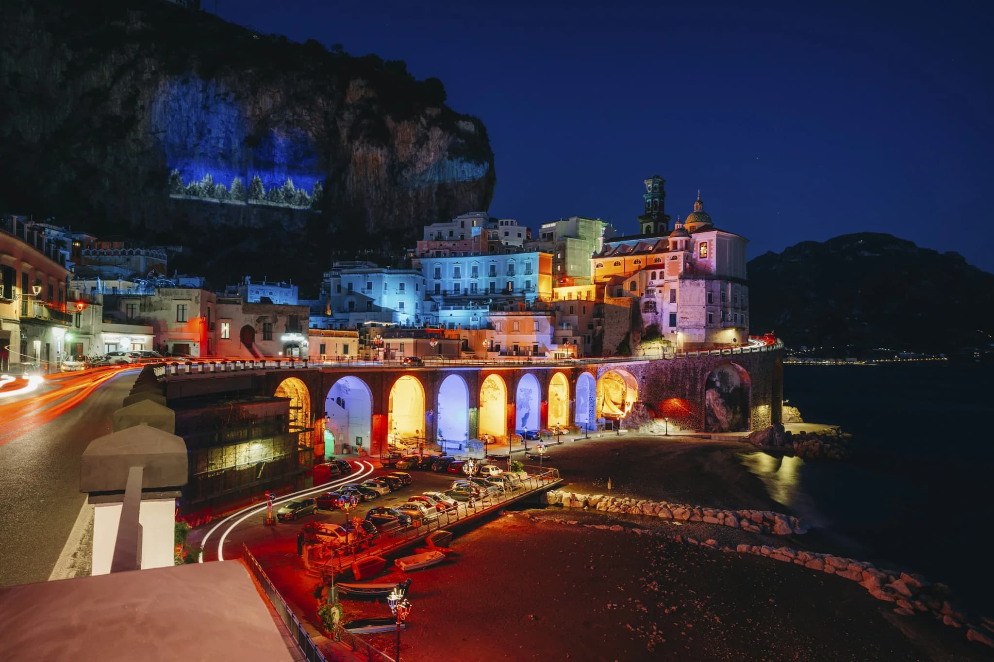 Atrani at night, the lit arches above the beach