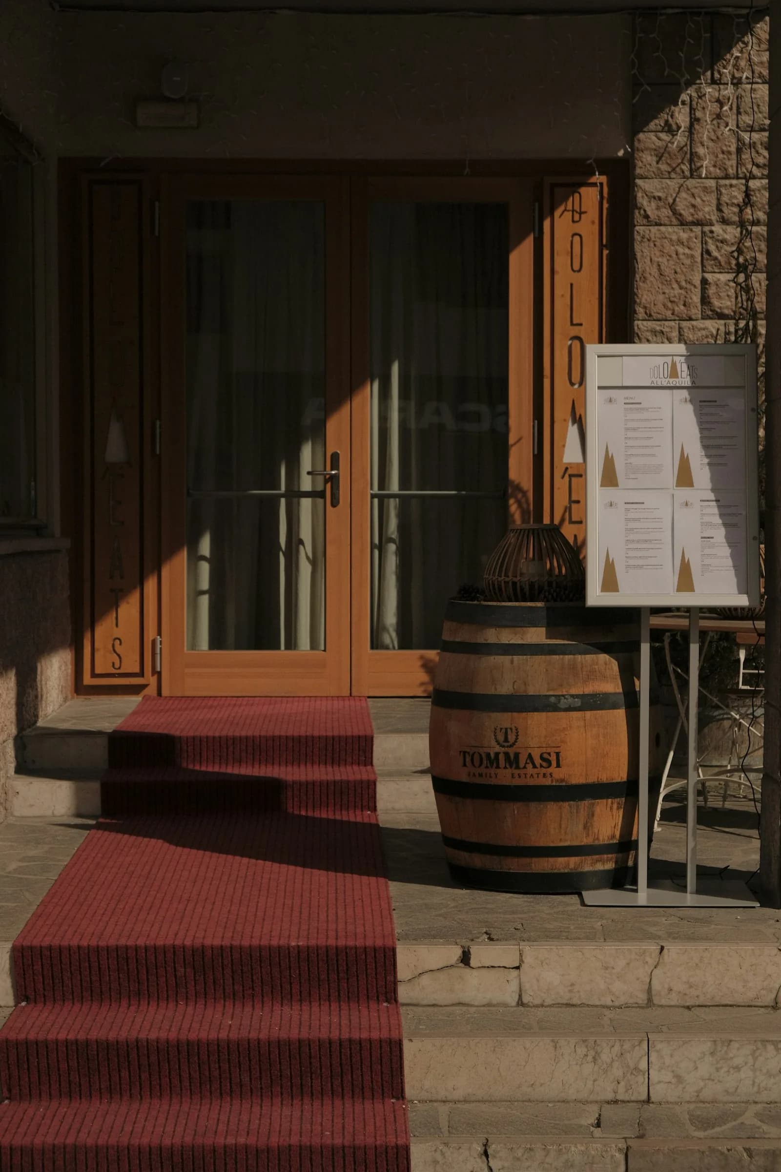 The door of a wine cellar, a barrel and the day’s board