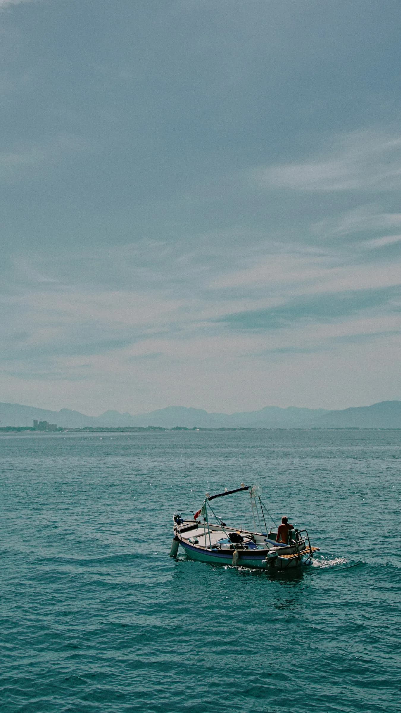 A lone rowing boat on a calm sea